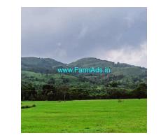 2 acre plain land with 2 wooden cottages for sale in Mudigere
