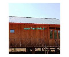 2 acre plain land with 2 wooden cottages for sale in Mudigere